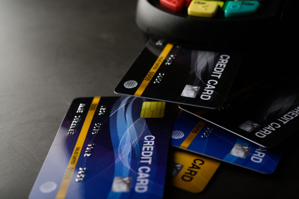 Photo of credit cards on a desk. To build wealth using the FOO system, be sure to tackle high-interest and revolving credit early on.