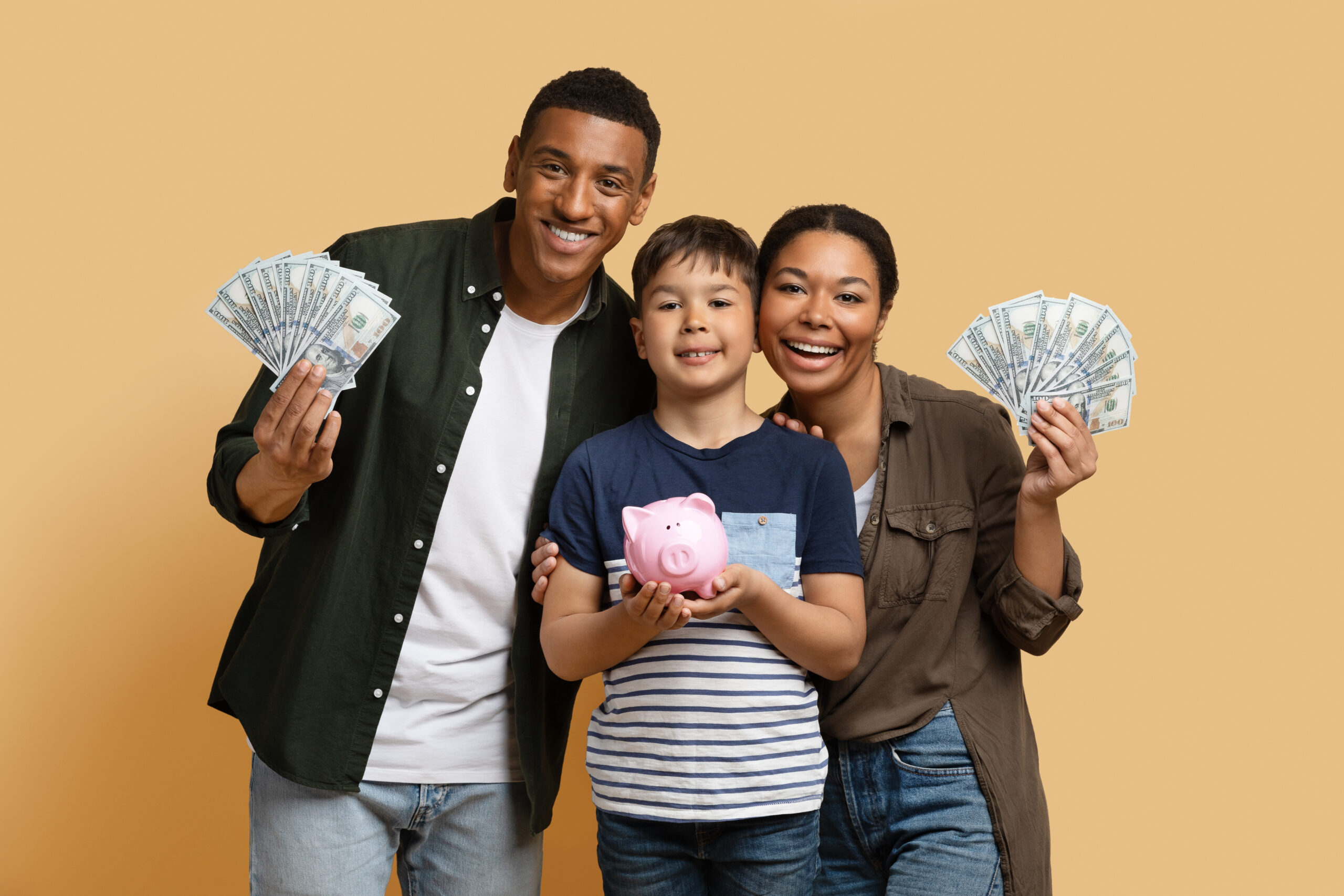 black family holding money cash and piggy bank 2023 11 27 04 57 43 utc scaled