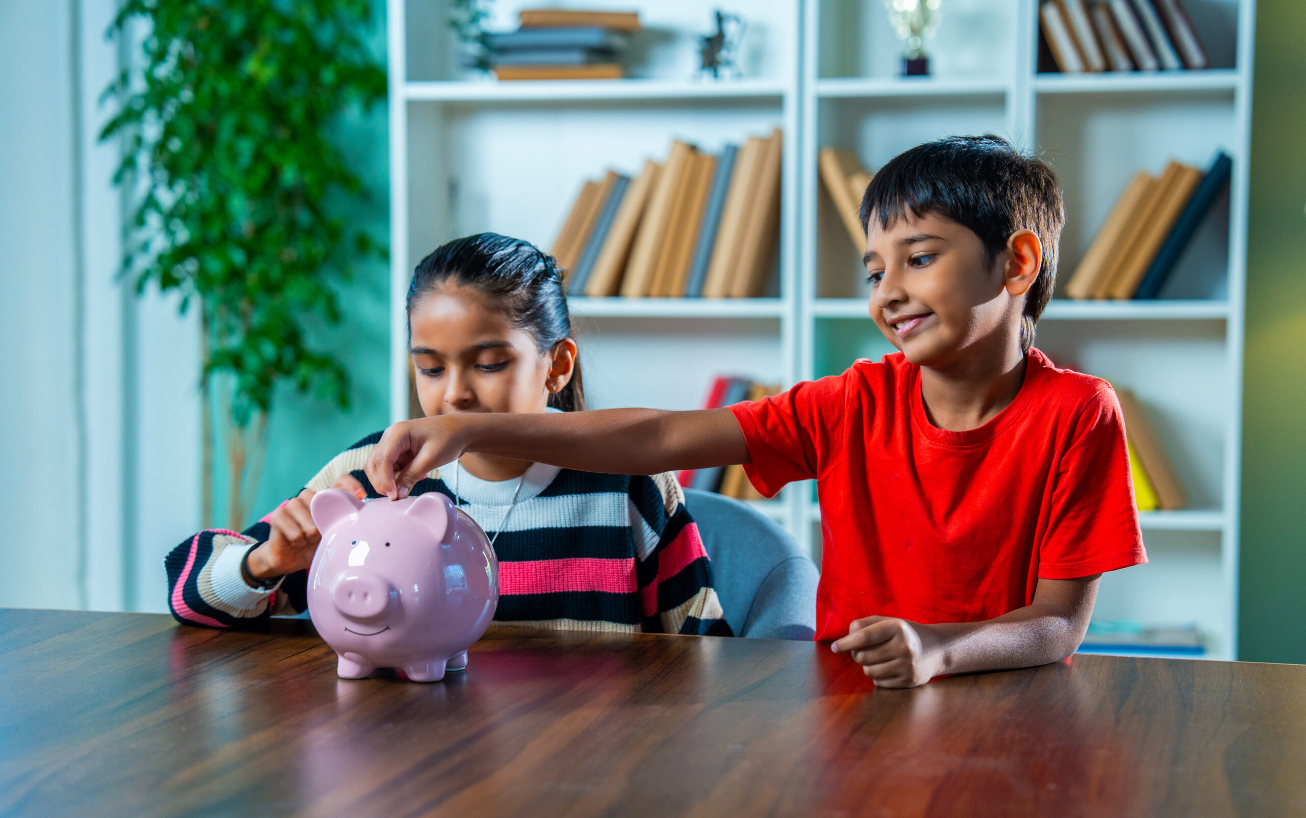 indian boy and girl siblings putting coins in pigg 2026 01 09 10 02 33 utc scaled